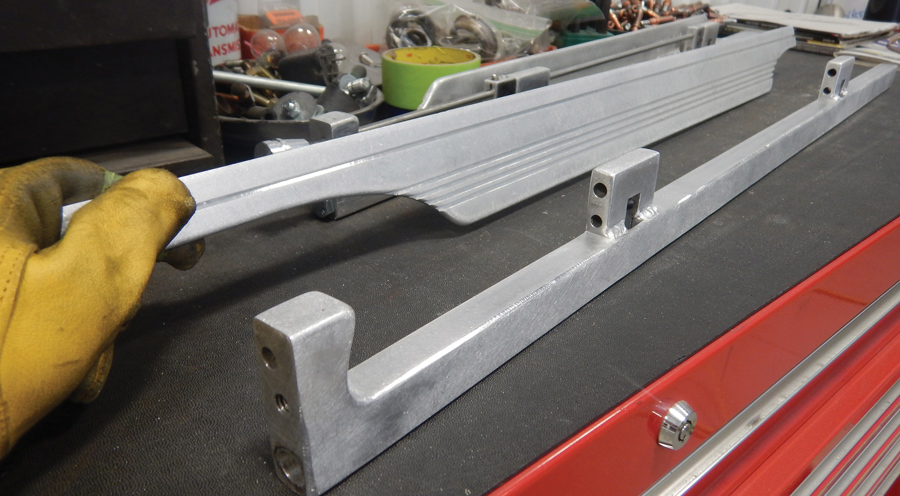 The sturdy hood hinges were completely hand fabricated. They allow the hood to hinge from either side, or the entire hood top can be removed by pulling two pins. Believe it or not,  the grooves in these  parts were made with a table saw!