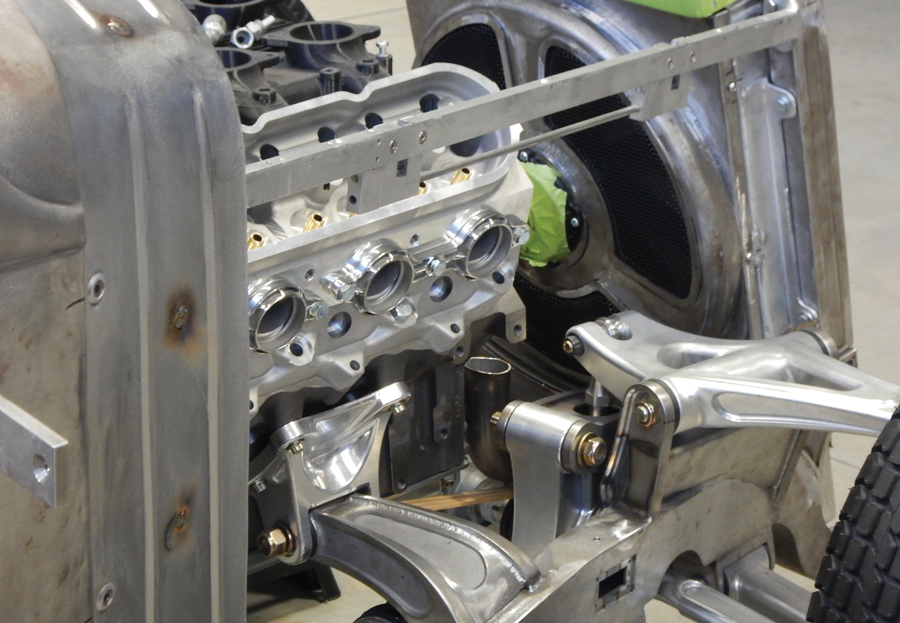 The motor mounts were fabricated in a style that matches the front control arms. The coilover suspension units are just barely visible below the mounts.