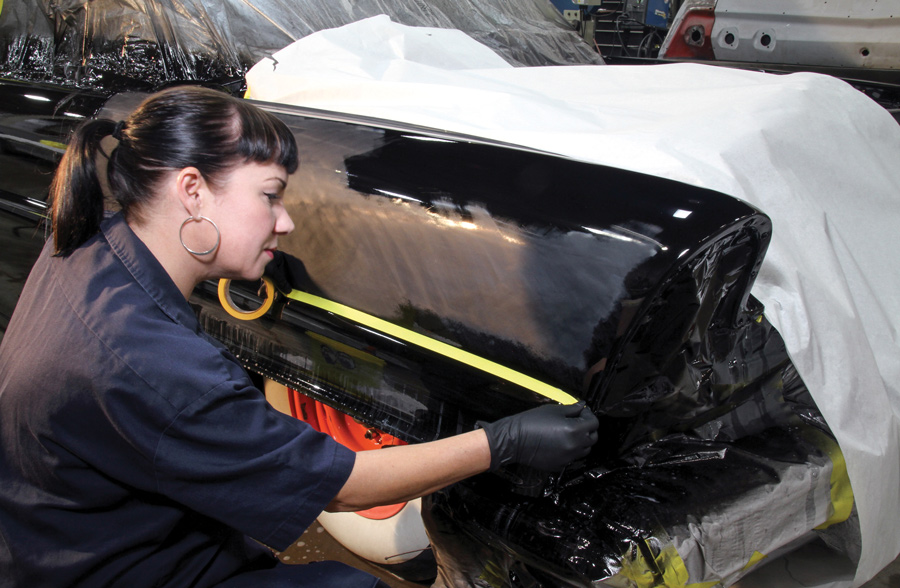Peaks, corners, and edges are the most vulnerable areas of a paintjob during wet-sanding, and as work moved lower, the “step” in the Lincoln’s front fender was taped off for protection. After the upper section is completed, the lower section will be tackled. 