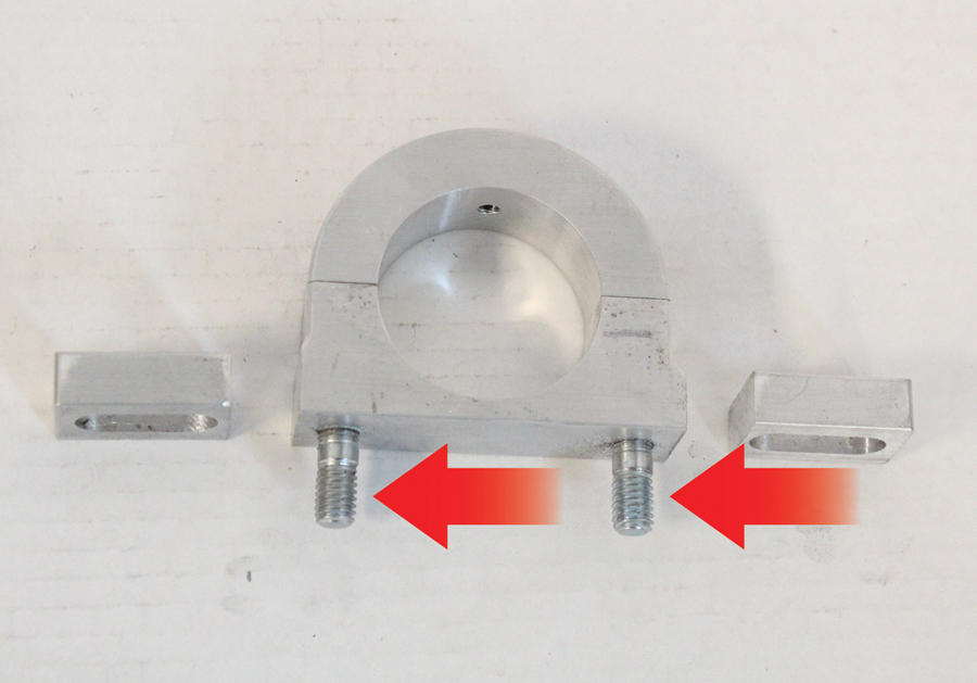 Due to the steering column recess in the Ford’s dashboard, the Flaming River dash mount was modified by cutting off the mounting ears. Then two holes were drilled and tapped for mounting studs <i>(arrows)</i>.