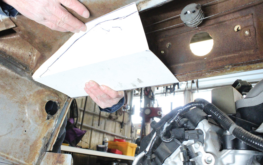 With the bottom of the heater plenum removed a paper pattern was made to form the replacement. The large hole in the cowl is where the windshield wiper motor mounts from the engine compartment side. 