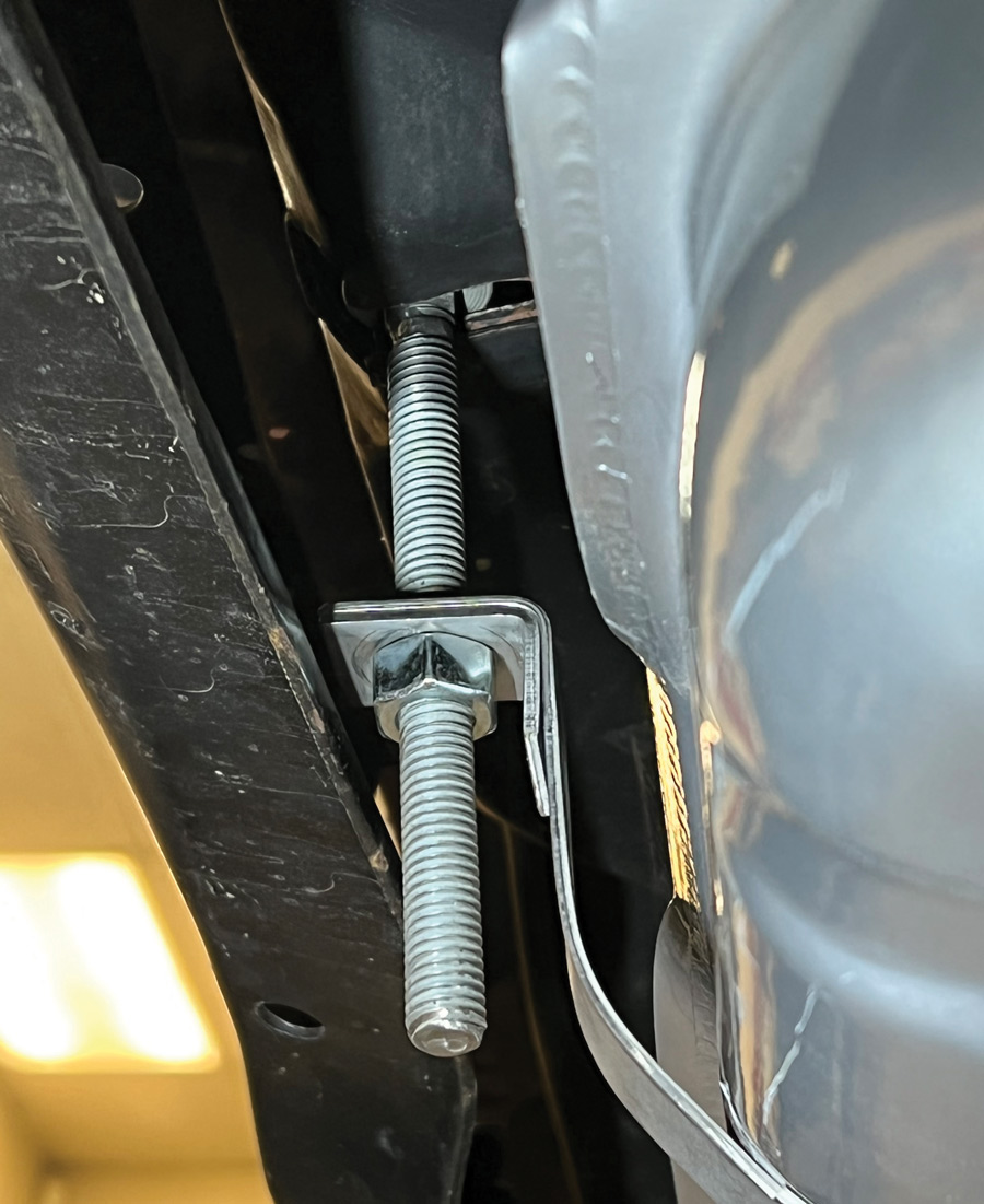 Although you can use the original hardware, we opted for new hardware for our installation. At the front of the tank (nearest rear bumper) a pair of drop-down threaded bolts and nuts are used to hold the forward portion of the tank within the straps. 