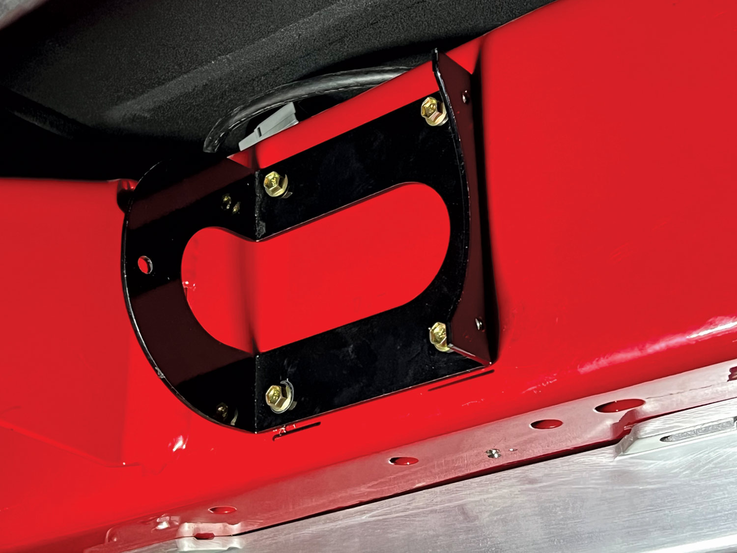the vacuum canister bracket installed on a car