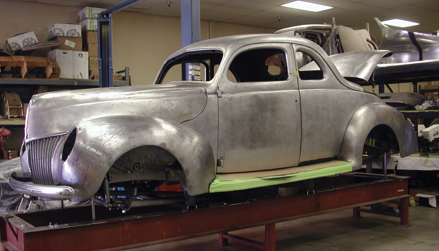unpainted shell of a '39 Ford DeLuxe Coupe