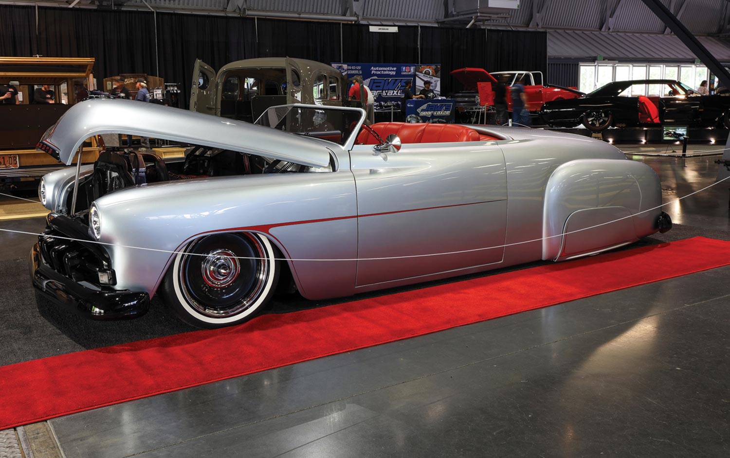 drivers side view of a silver ’51 Plymouth with its hood open