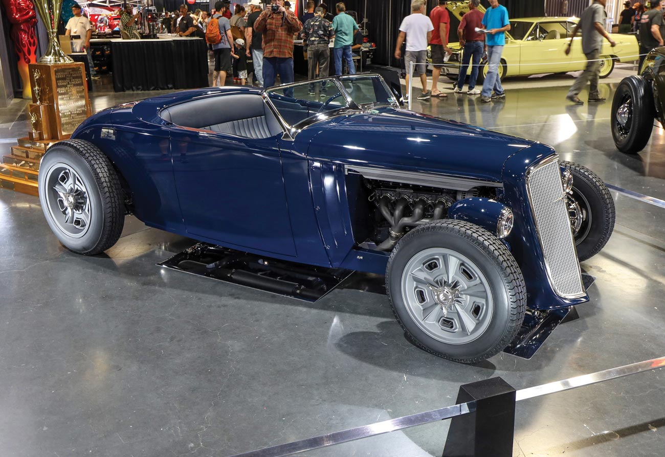 passenger side view of a deep blue ’34 Chevy roadster
