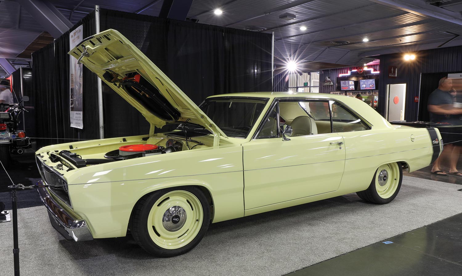 drivers side view of a pastel yellow ’72 Plymouth Scamp with its hood open