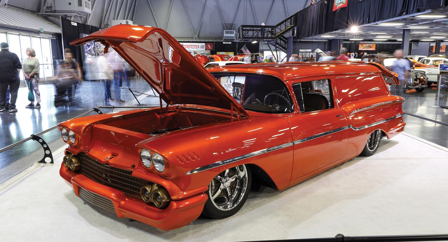 three quarter front view of a metallic burnt orange ’58 Chevy Delray Sedan Delivery with its hood open