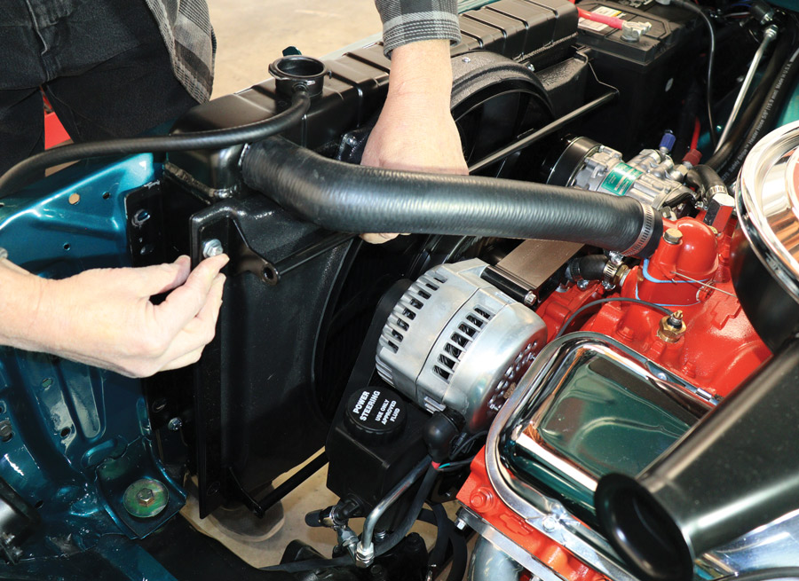 Lindfors inserted the fan/shroud mounting bolts at the top of the driver and passenger side on the fan/shroud first followed by inserting the fan/shroud lower two mounting bolts