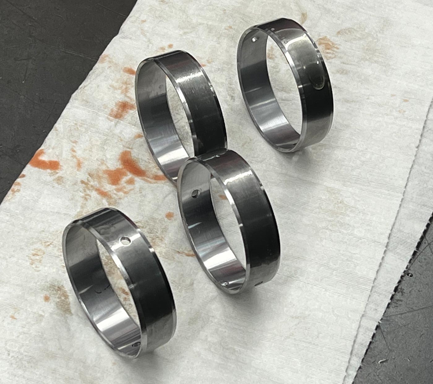 two Dura-Bond cam bearing sets (PN DUR-CH-10) sit on a work surface