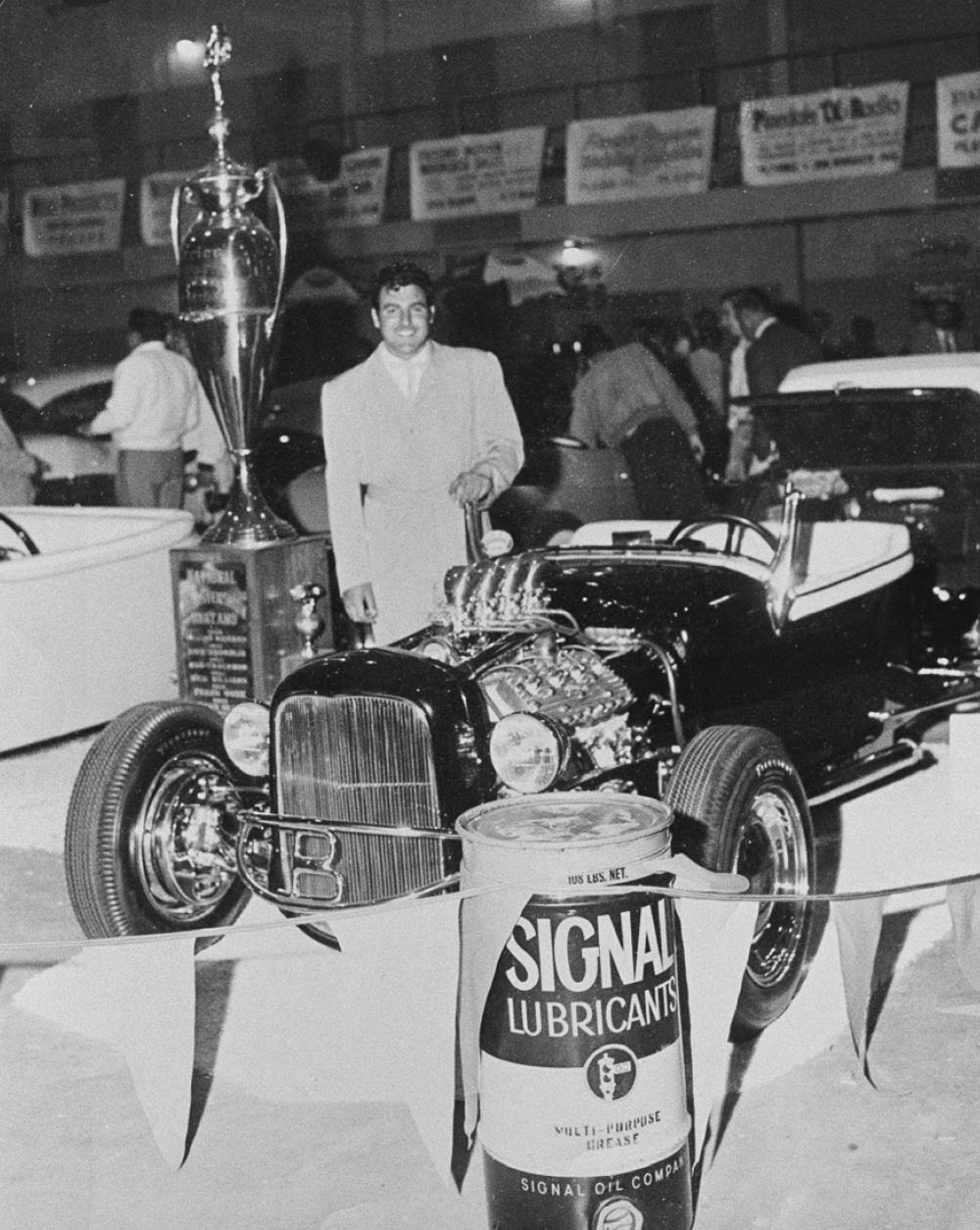 A resplendent Mr. Gejeian styles up to pose with the big AMBR trophy at Oakland, 1955