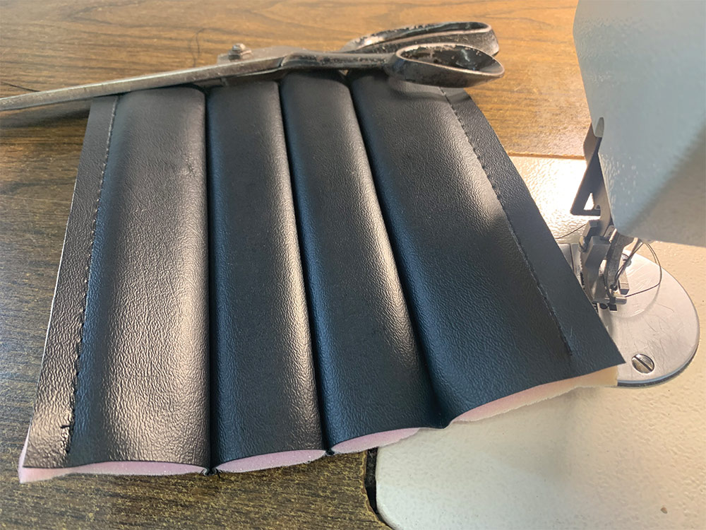 Pleated foam with vinyl cover