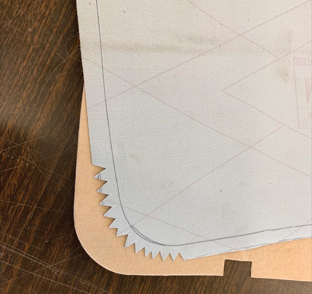 Trimmed material with relief cuts along corner