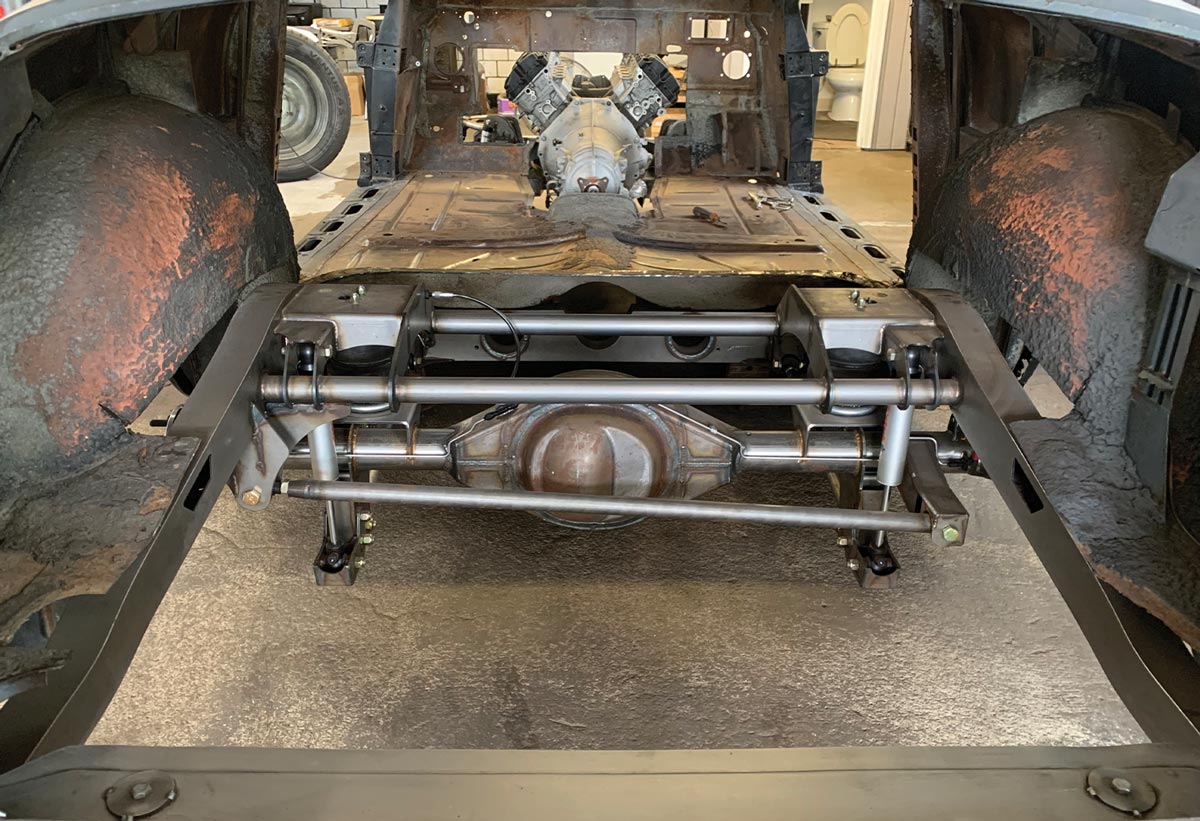 the original floor is removed exposing the Roadster Shop parallel four-link suspended, 9-inch rear, and Ridetech airbags