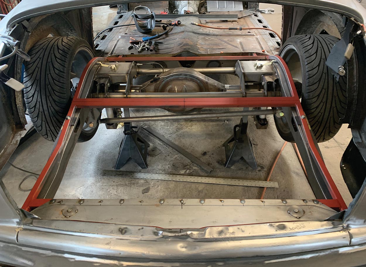 the floor subframe is test-fitted to the Roadster Shop chassis