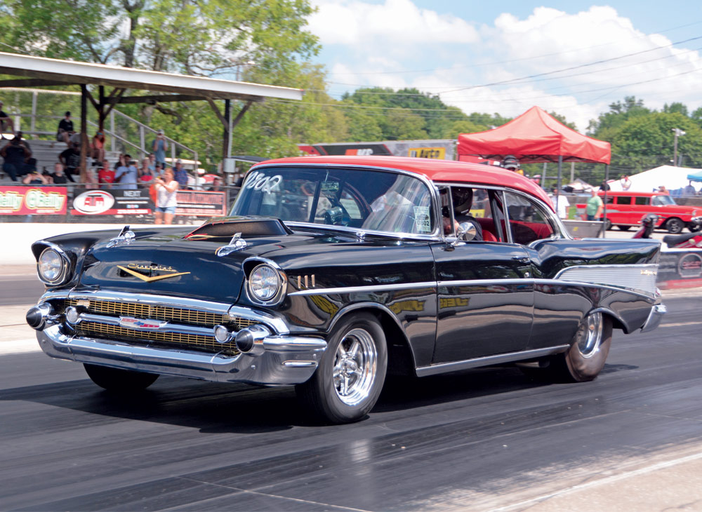 Black '57 Bel-Air street style dragster on strip