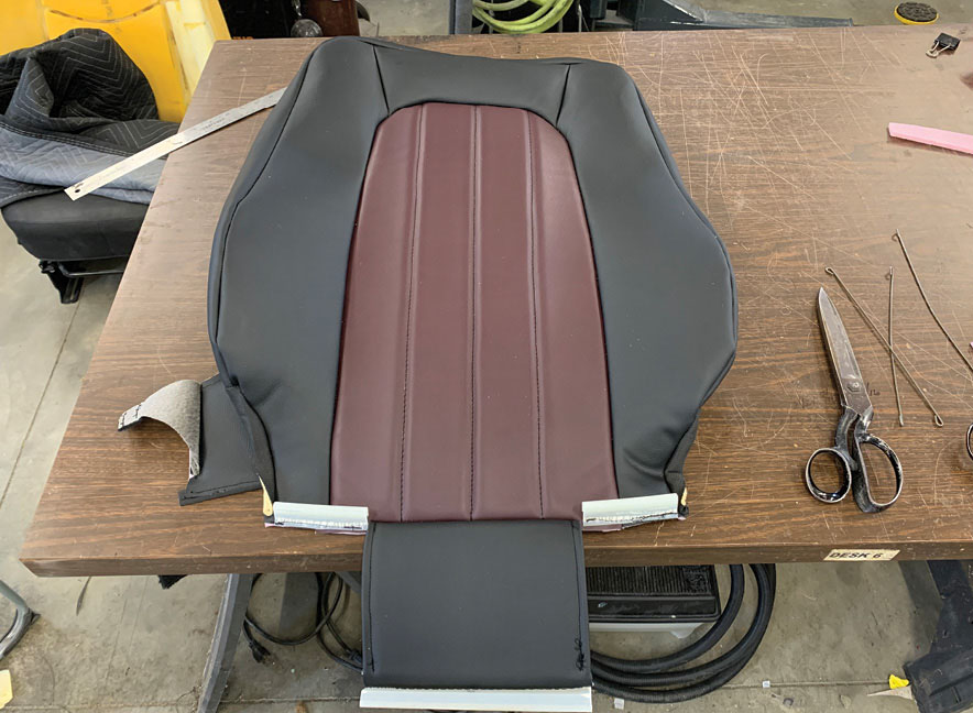 Here the sides of the seat cover have been folded back before being attached the molded foam cushion.
