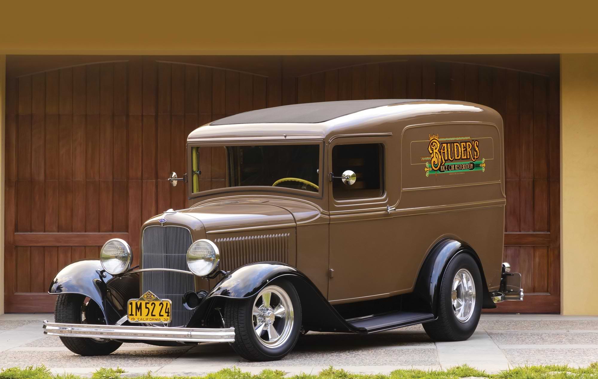 three quarter drivers side view of the '32 Ford Panel in brown, with black fenders and a side graphic text reading "Bauder's Race Car Restoration"