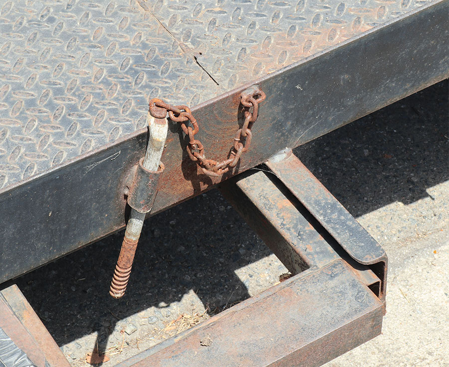 Rusted trailer safety chains on the Model A frame