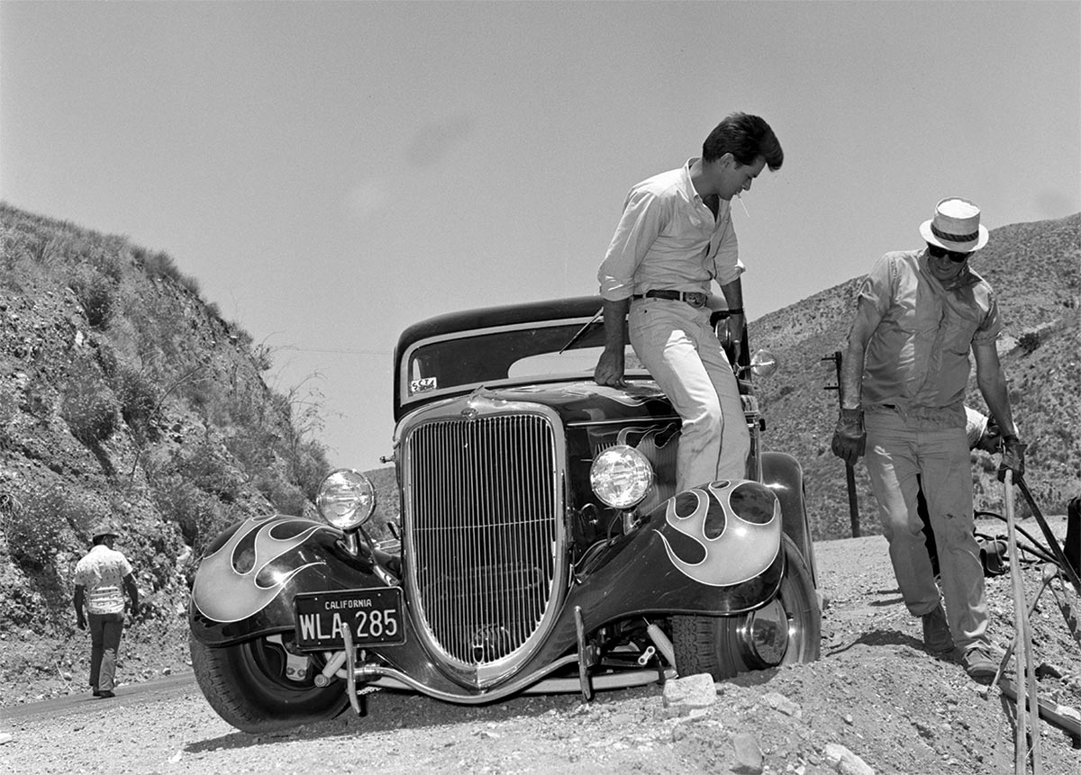 Martin Sheen standing on the coupe's running board on location