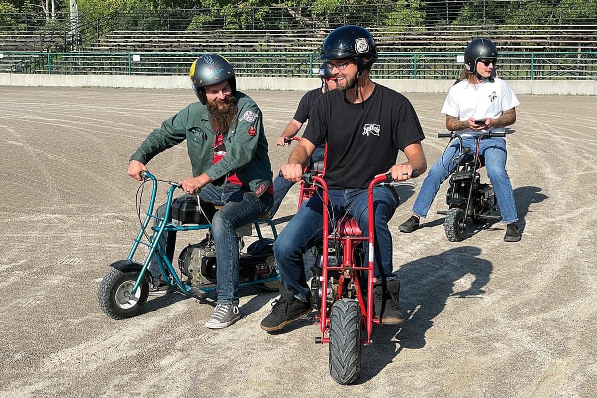 four men riding minibikes