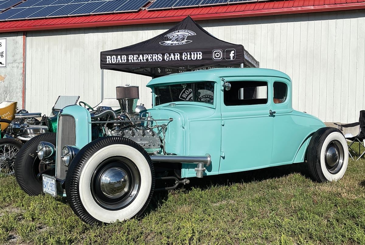 a pastel teal Model A with the hood removed