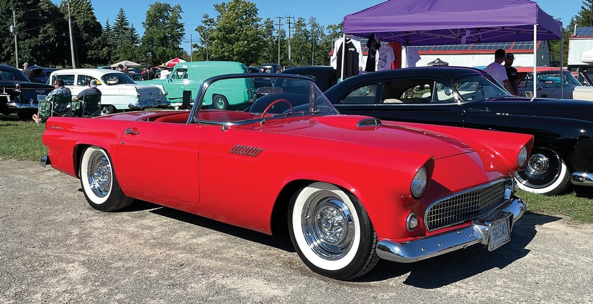 a classic red Thunderbird with the top down