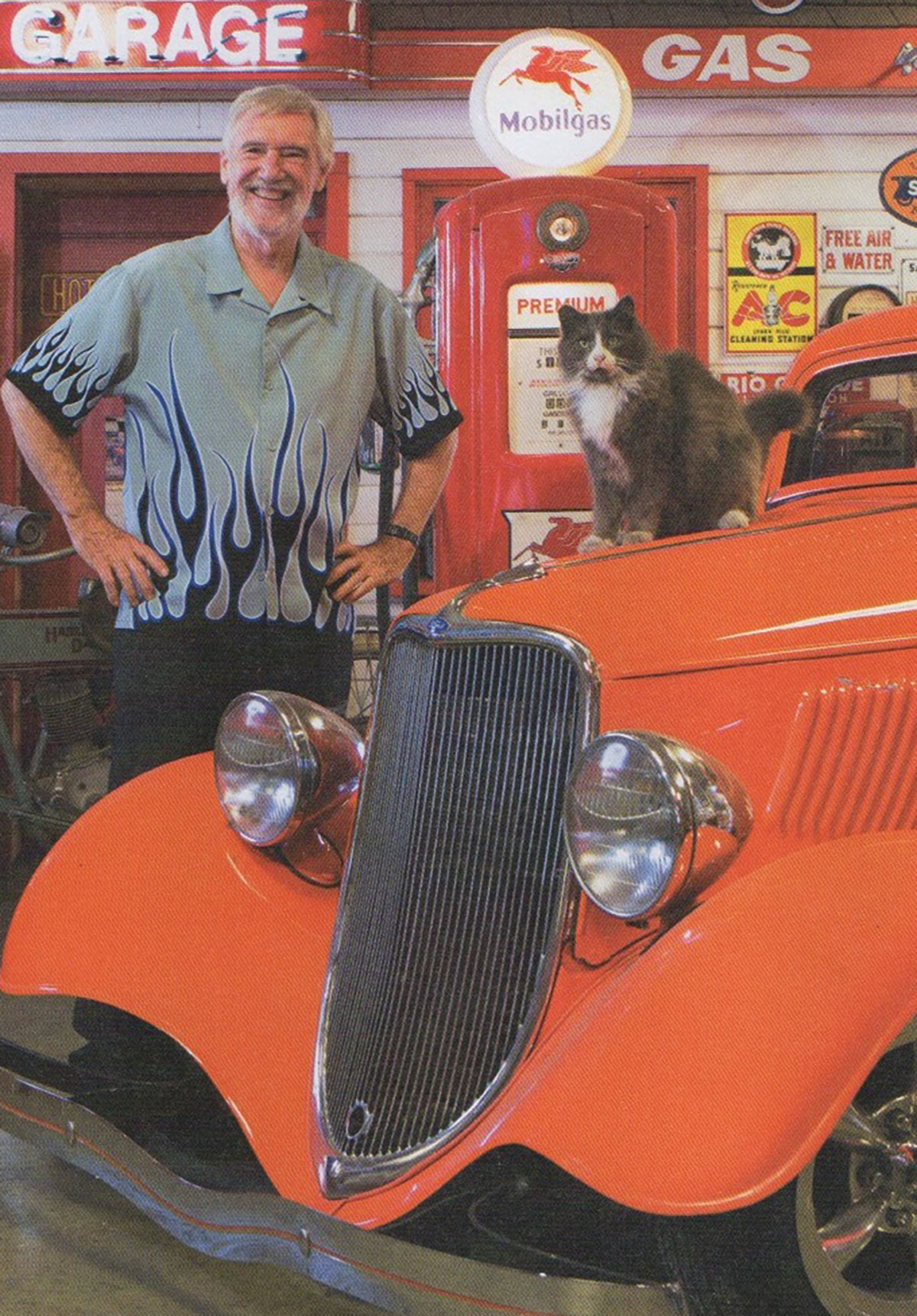 Wood with his ’33 Ford sedan and Fluffy the guard cat. Larry has a clowder of cats that take care of the shop during off hours.