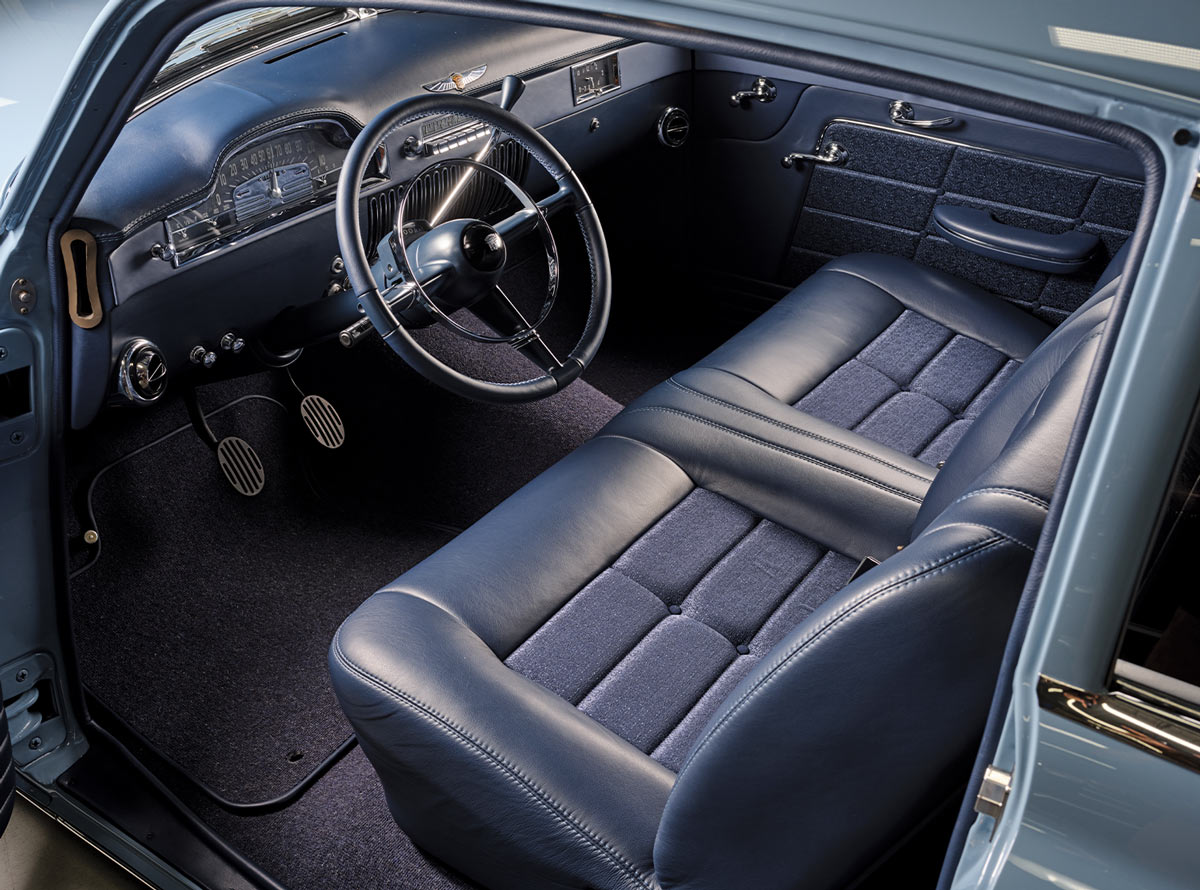 driver's side inteior view of the ’49 Cadillac Series 62 Sedanette, showing the steering, dashboard, seating and pedals