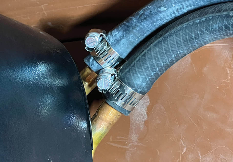 two heater hoses clamped to the heater and passing through the grommet filled holes