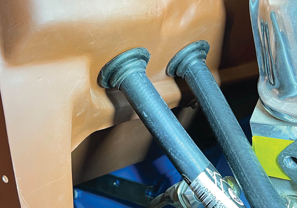 two heater hoses clamped to the heater and passing through the grommet filled holes in the lower portion of the firewall.