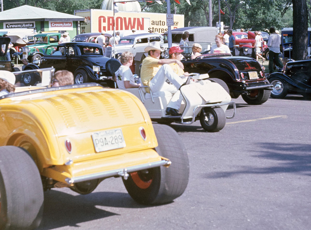 OK, you just knew I would have a pic of me from the 1974 NSRA Nats in St. Paul, Minnesota. You will have to look hard. Not in a hot rod, how about a golf cart? The late-Tex Smith of journalism fame, early L.A. Roadsters member, and just all-around incredible mentor is seated “shot gun” while his son, Scott, is in the back and I’m driving.