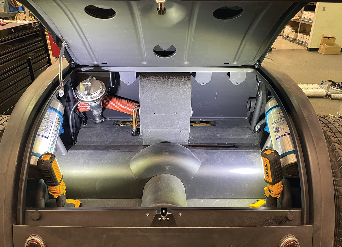 Inside the trunk is a Halibrand Indycar fuel filler, two fire suppression bottles (one for the engine compartment and the other covers the fuel tanks). That box in the center houses the custom Vintage Air climate-control system.