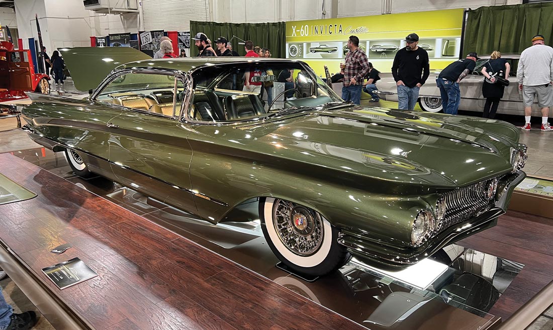 three quarter passenger side view of an olive green ’60 Buick with an open tailgate