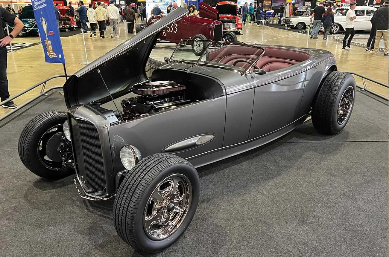 three quarter drivers side view of a slate gray cabriolet highboy Muroc roadster with its hood lifted