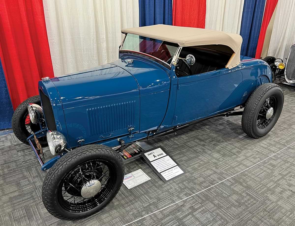 three quarter drivers side view of a blue ’28 Ford highboy roadster