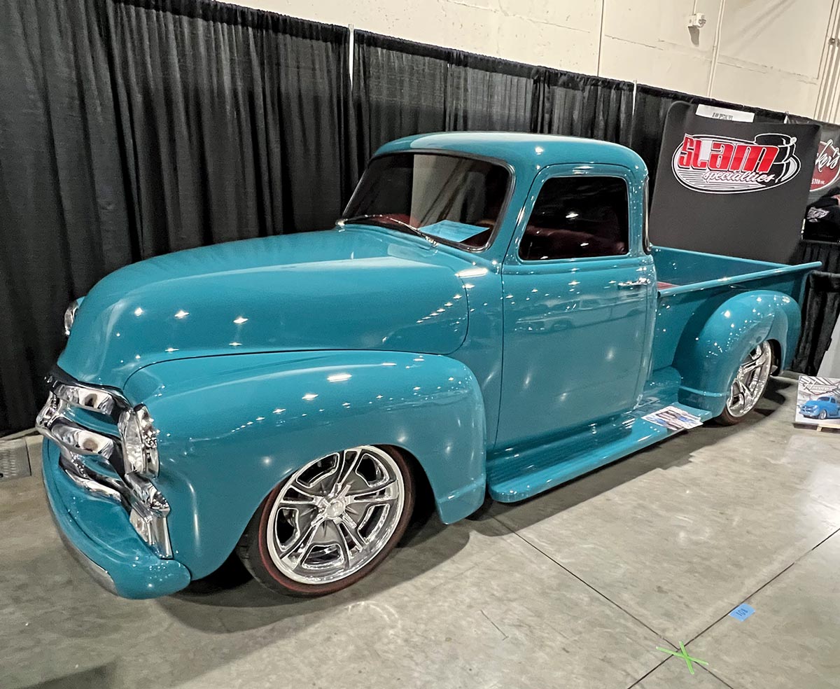 three quarter drivers side view of a baby blue ’54 Chevy pickup