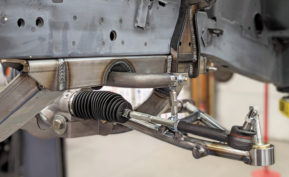 With the K-member properly located, the attachment bolts are then tightened to 150 lb-ft.