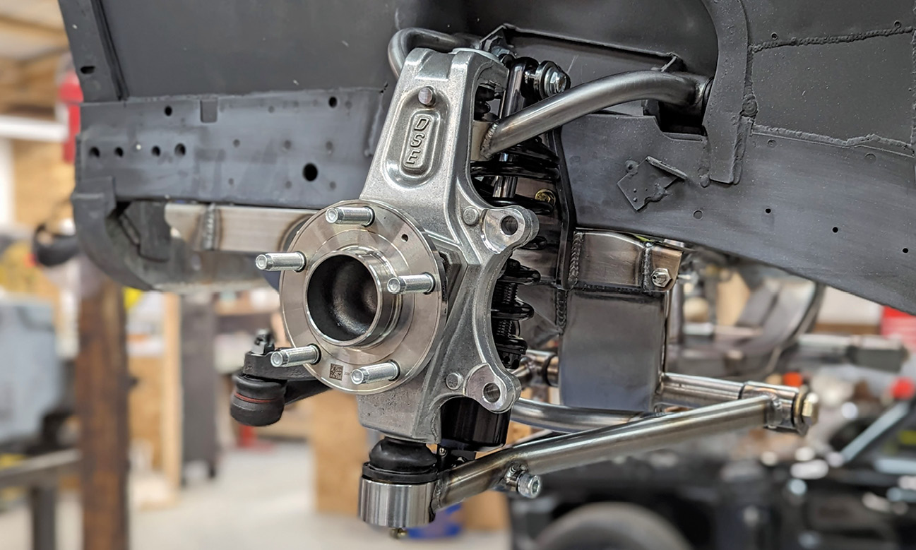 The C6 Corvette-style forged aluminum knuckle assembly is significantly taller than other designs, requiring a minimum 18-inch wheel. Rather than a conventional spindle, the Corvette uses a modular hub/bearing that fits in the knuckle and is bolted in place. 