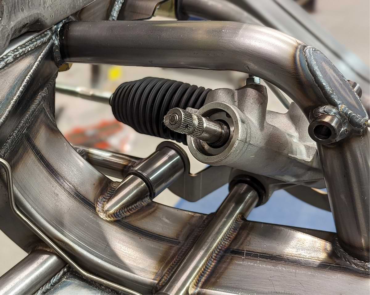 Typical of AME products, the design and welding are superb. For the straightest possible alignment with the steering column, the rack-and-pinion unit tucks under the engine mount. 