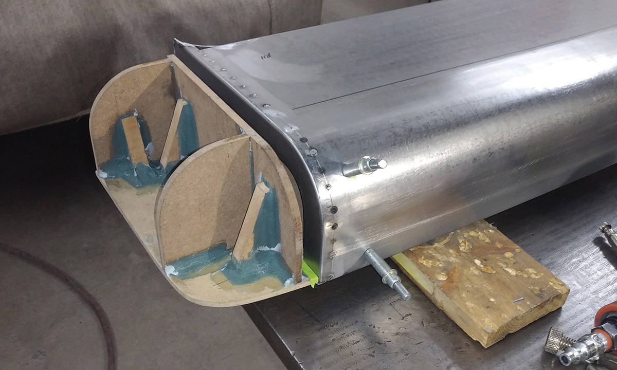 One of the hammerformed parts is shown tack-welded to the outer edge of the centersection. Placing the weld away from the corner keeps the corners crisp and uniform.