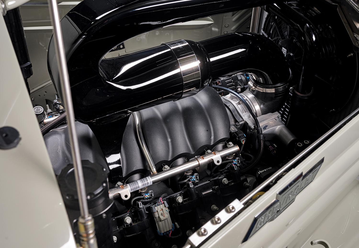 view of the '37 Chevy pickup's engine behind a hood side panel