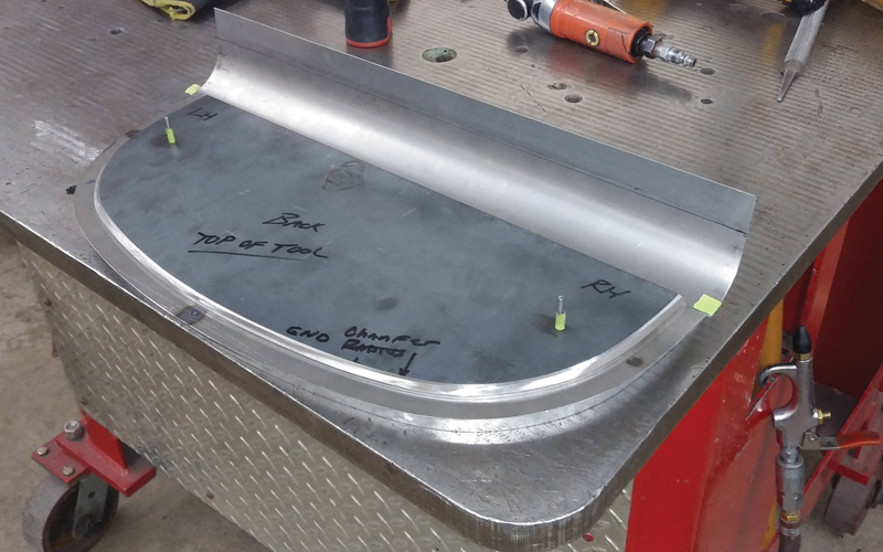 A separate panel is made to fill in the nose behind the grille, covering the front axle and the daylight behind it. A hammerform will be used to flange the edge of this panel.