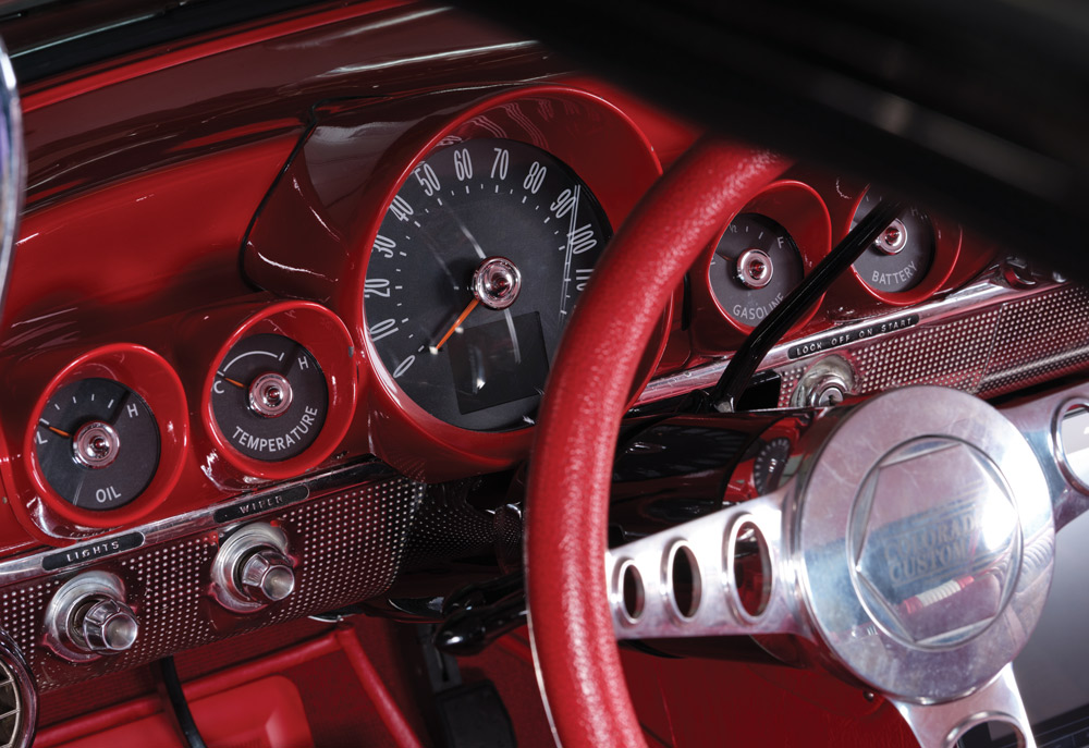 close up of red steering wheel and gauges