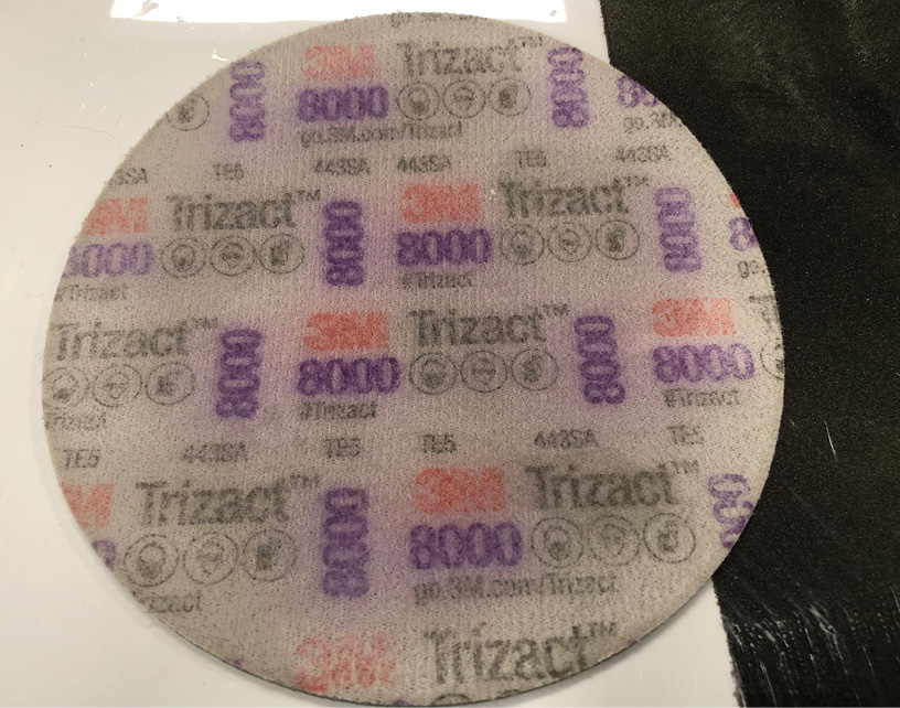 Finest grit available, Trizact 8,000-grit, is used dry on a DA (dual-action orbital) and leaves the paint polished with minimum compounding required to finish.