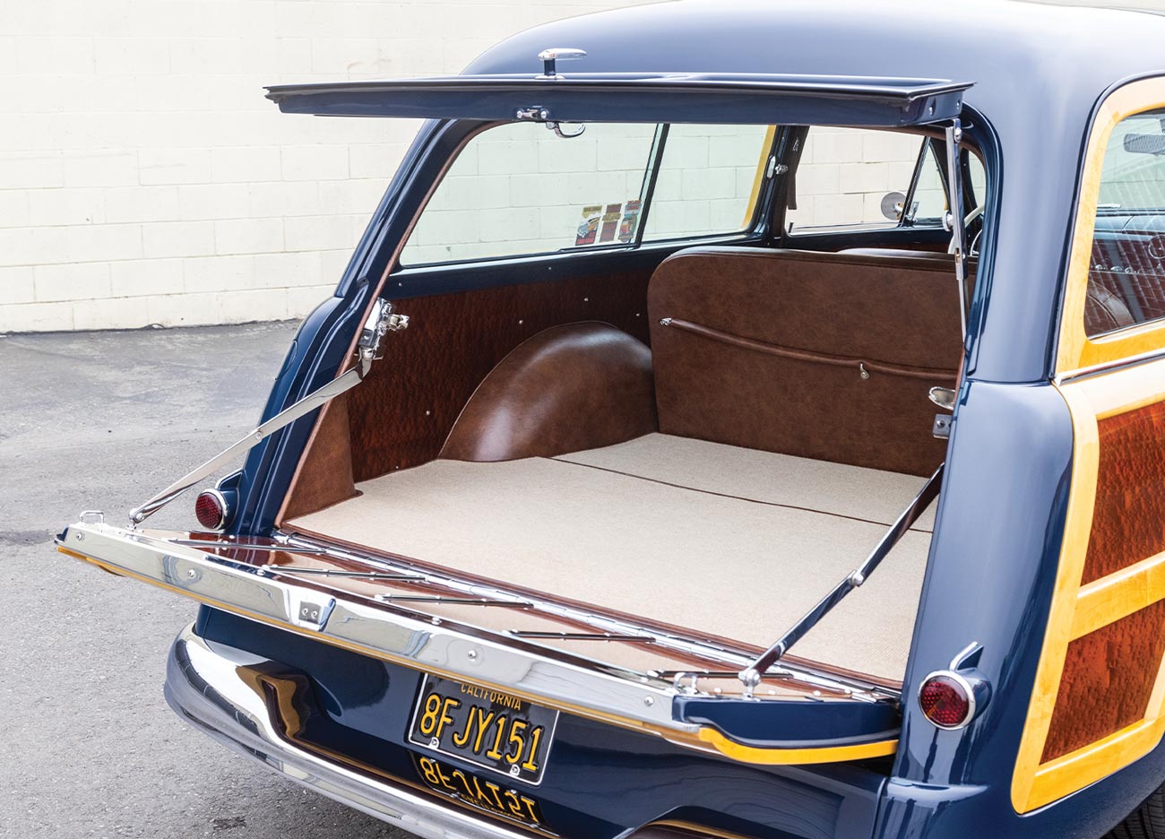 3/4ths view of the '50 Ford Woodie's open two-way tailgate