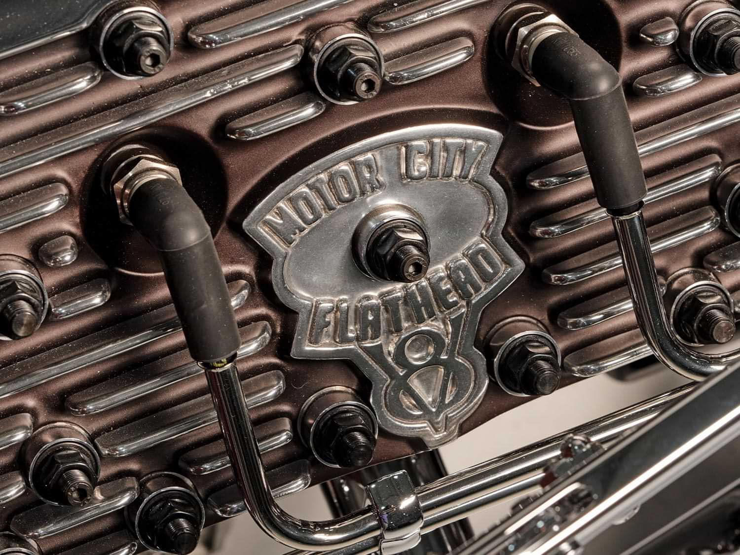 close view of the Motor City Flathead emblem an engine cylinder head