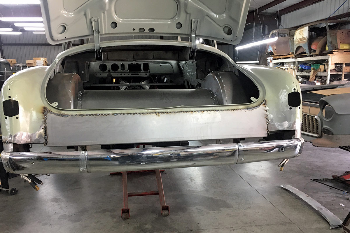 The rear bumper was flipped upside down then reshaped to conform to the back of the fenders. A custom pan fits between the bumper and the body.