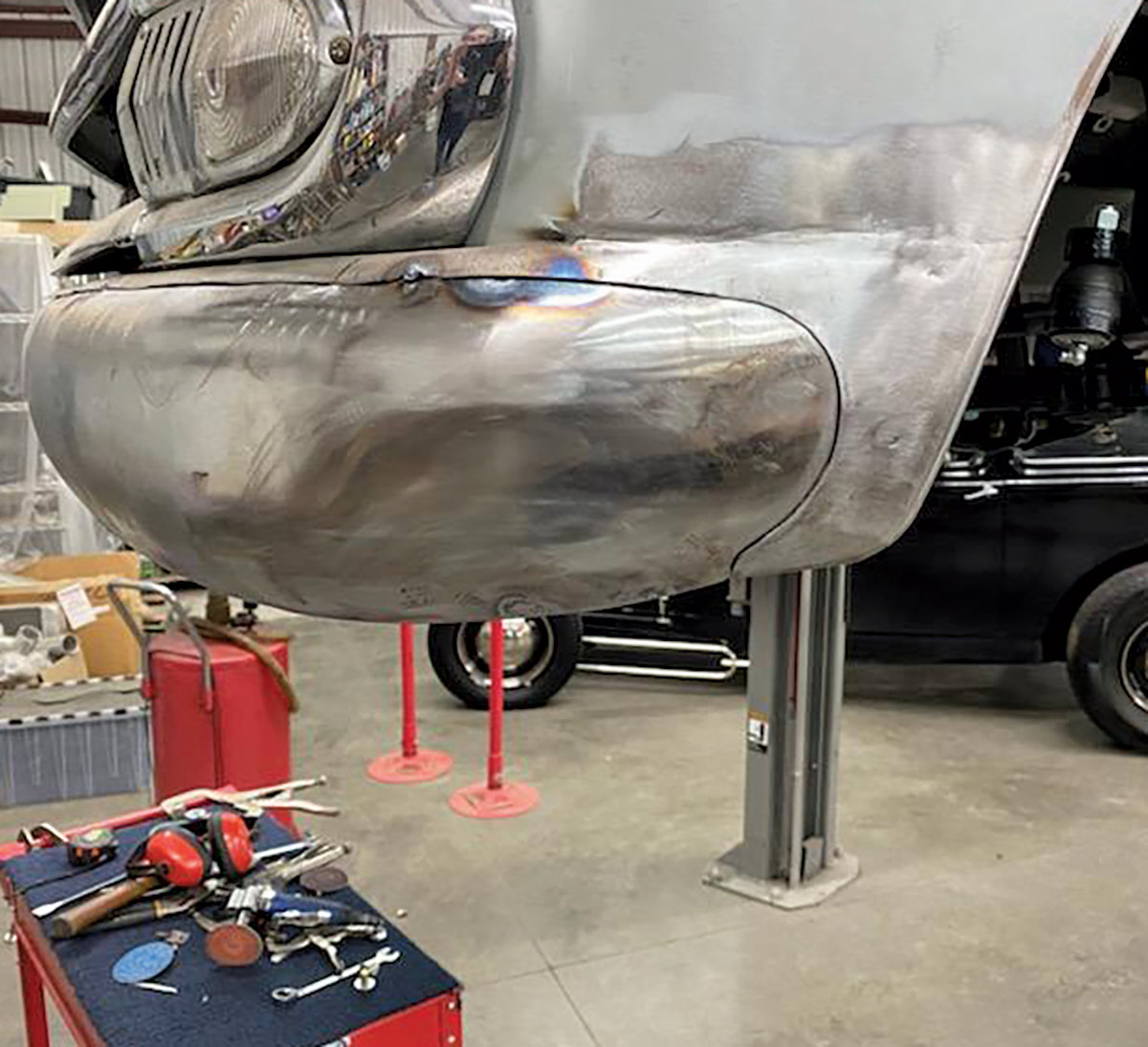 This sideview in bare metal shows the craftsmanship involved in fitting the front bumper to the front fenders. Not as obvious is the reshaping of the front wheelwell.