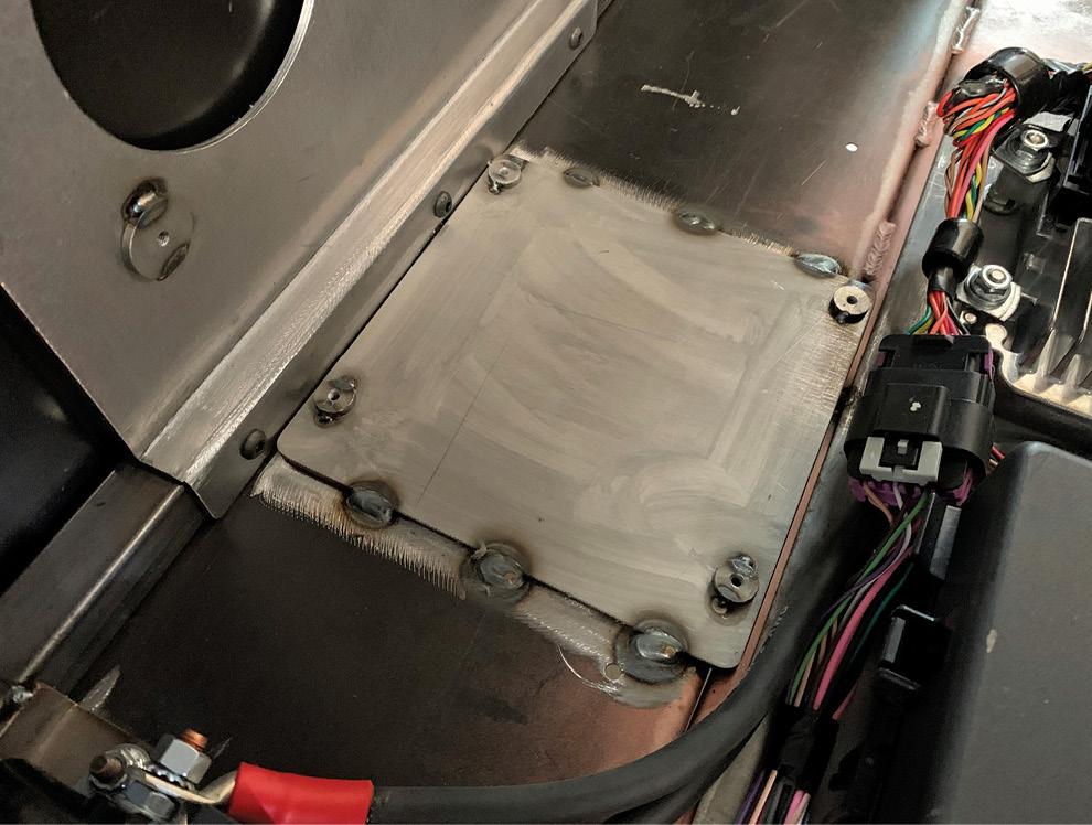 Notice the welded nut inserts on the four corners that allow for easy mounting without dealing with nuts on the backside. The mounting plate is then welded to the floorpan once the wiring path is laid out. 